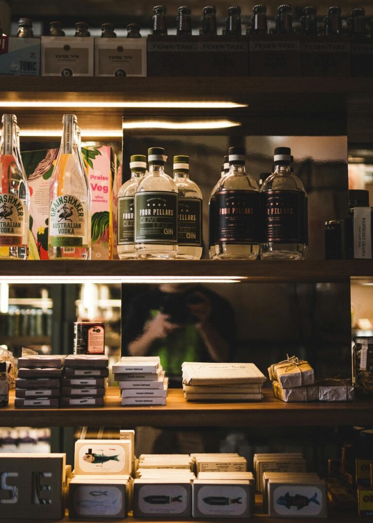 A neatly arranged display of various bottles and packaged items on wooden shelves indoors.